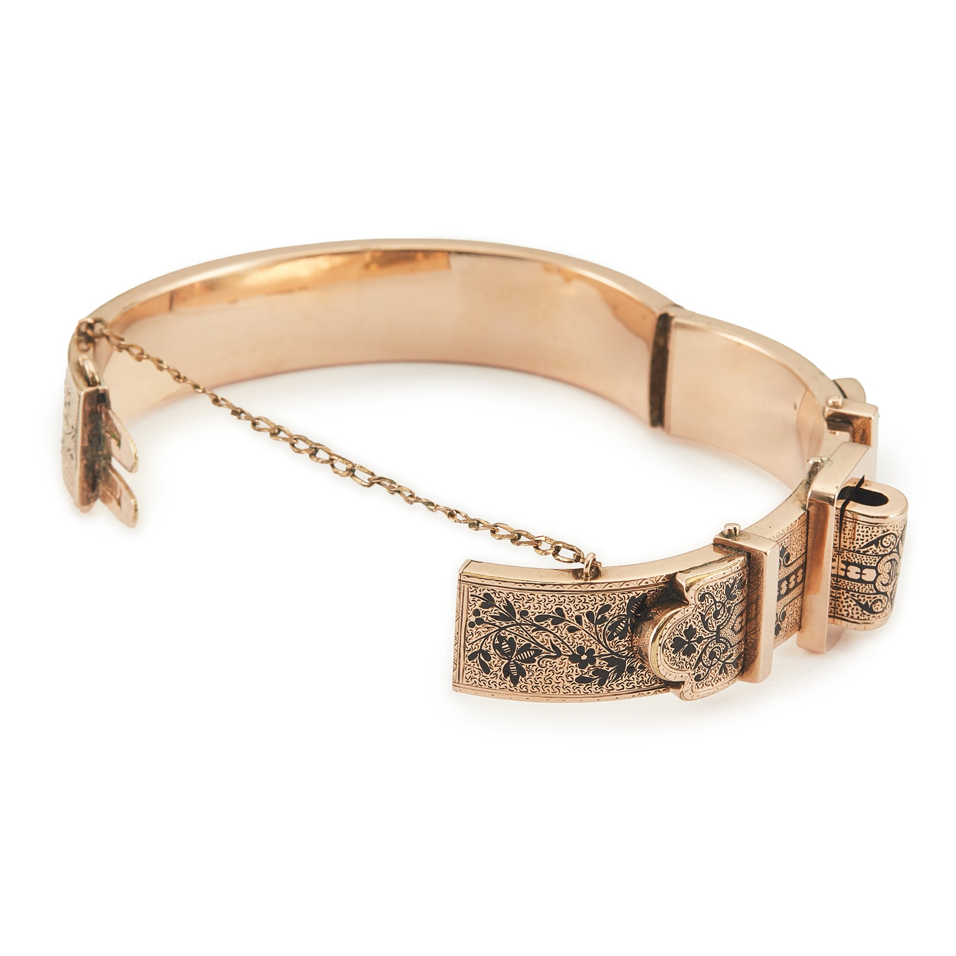 Exquisite Victorian 9ct rose gold hollow buckle bangle, embellished with beautiful intricate black enamel floral design. Opens with hinge mechanism. Safety chain attached.
