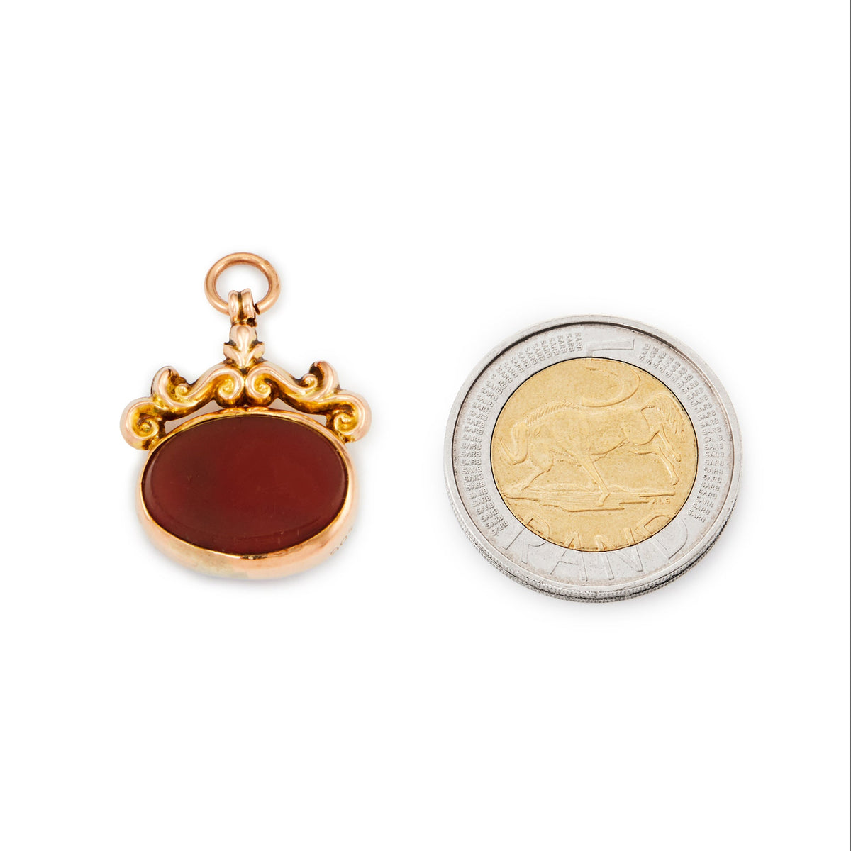 Quaint miniature Victorian 9ct rose gold fob with repoussé design, set with a bloodstone on one side and a carnelian on the other side.