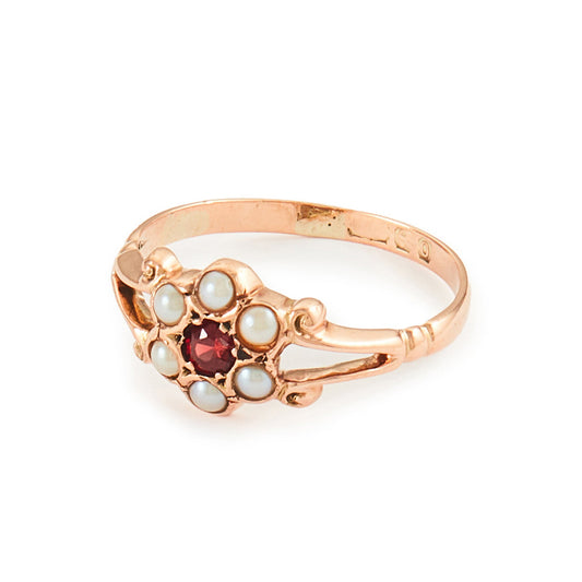 Dainty Victorian 9ct rose gold ring with six seed pearls and a centre garnet in a flower setting.