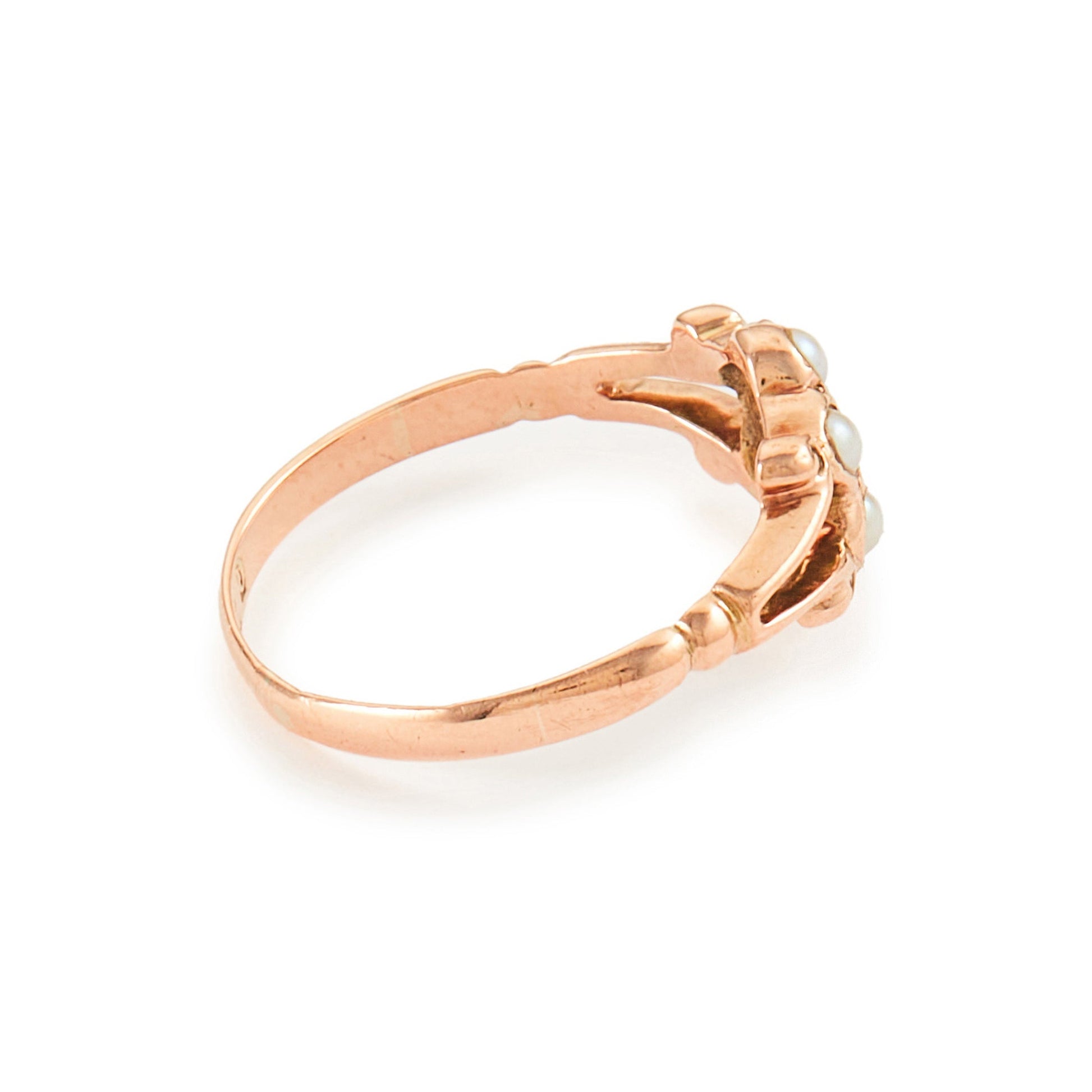 Dainty Victorian 9ct rose gold ring with six seed pearls and a centre garnet in a flower setting.