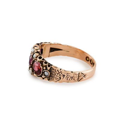 Pretty Victorian 9ct rose gold ring, set with three purple-pink garnets and eight small seed pearls. Beautiful engraving on shank.