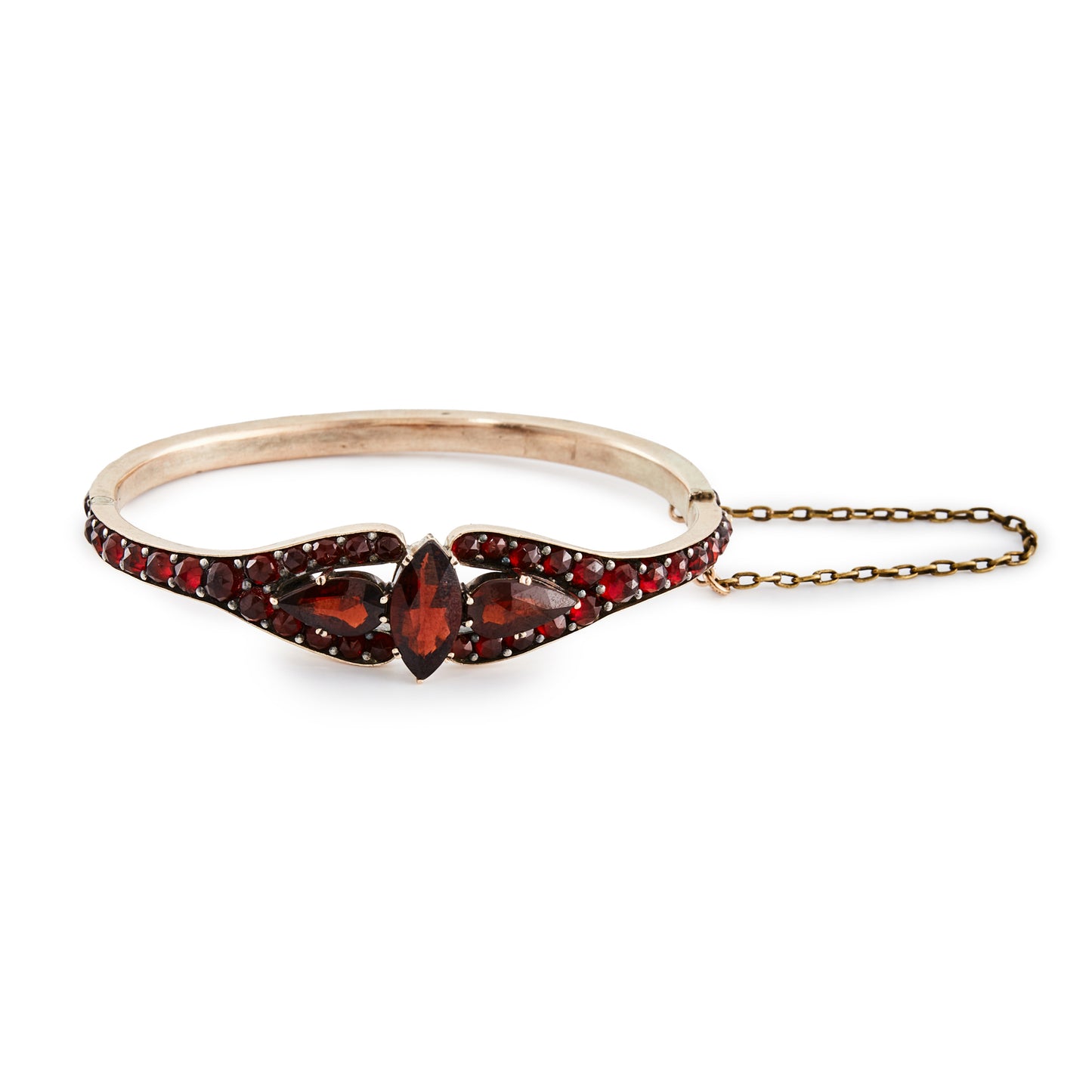 Gorgeous Victorian bangle set with beautifully faceted, deep red Bohemian garnets in a gold plated setting. Safety chain attached.