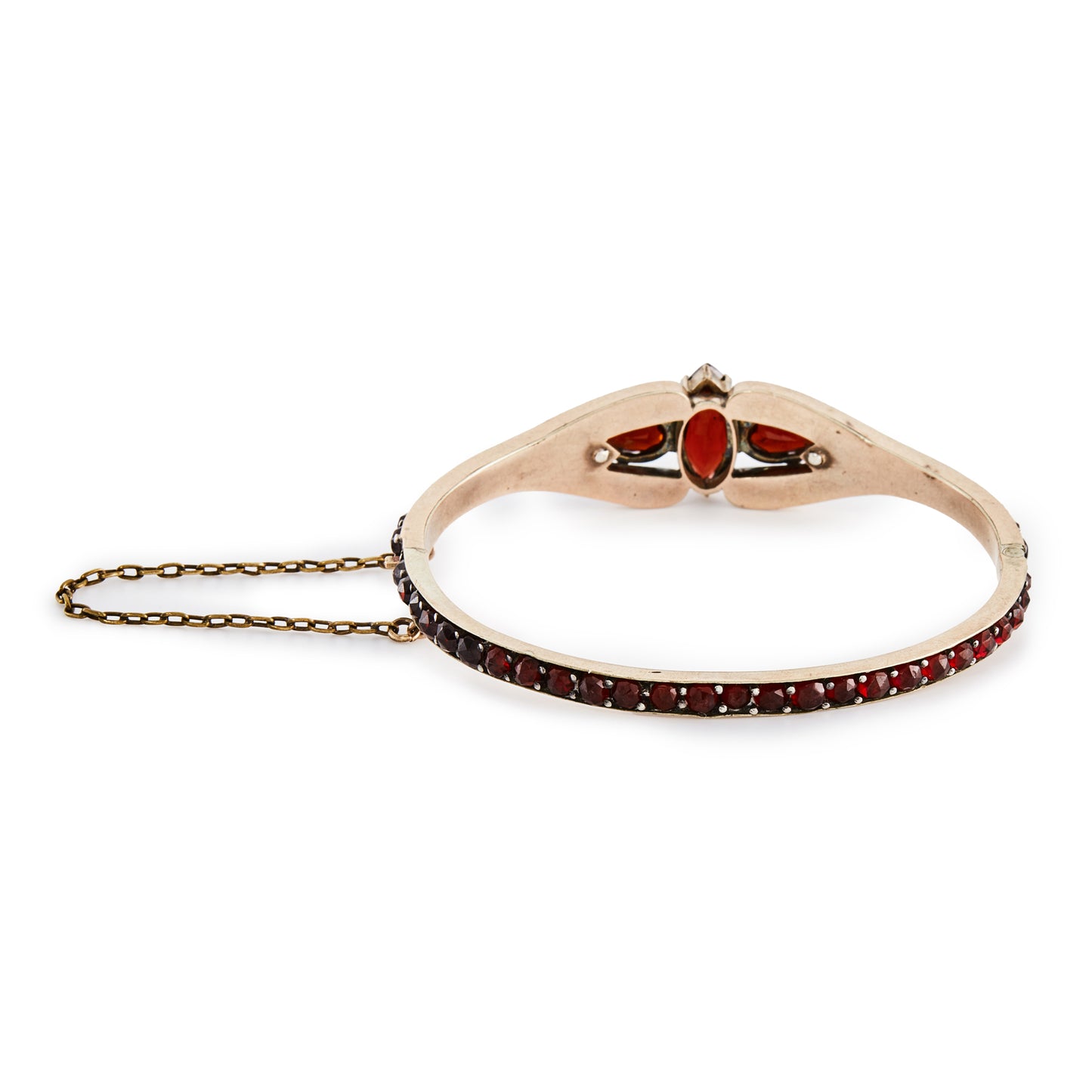 Gorgeous Victorian bangle set with beautifully faceted, deep red Bohemian garnets in a gold plated setting. Safety chain attached.