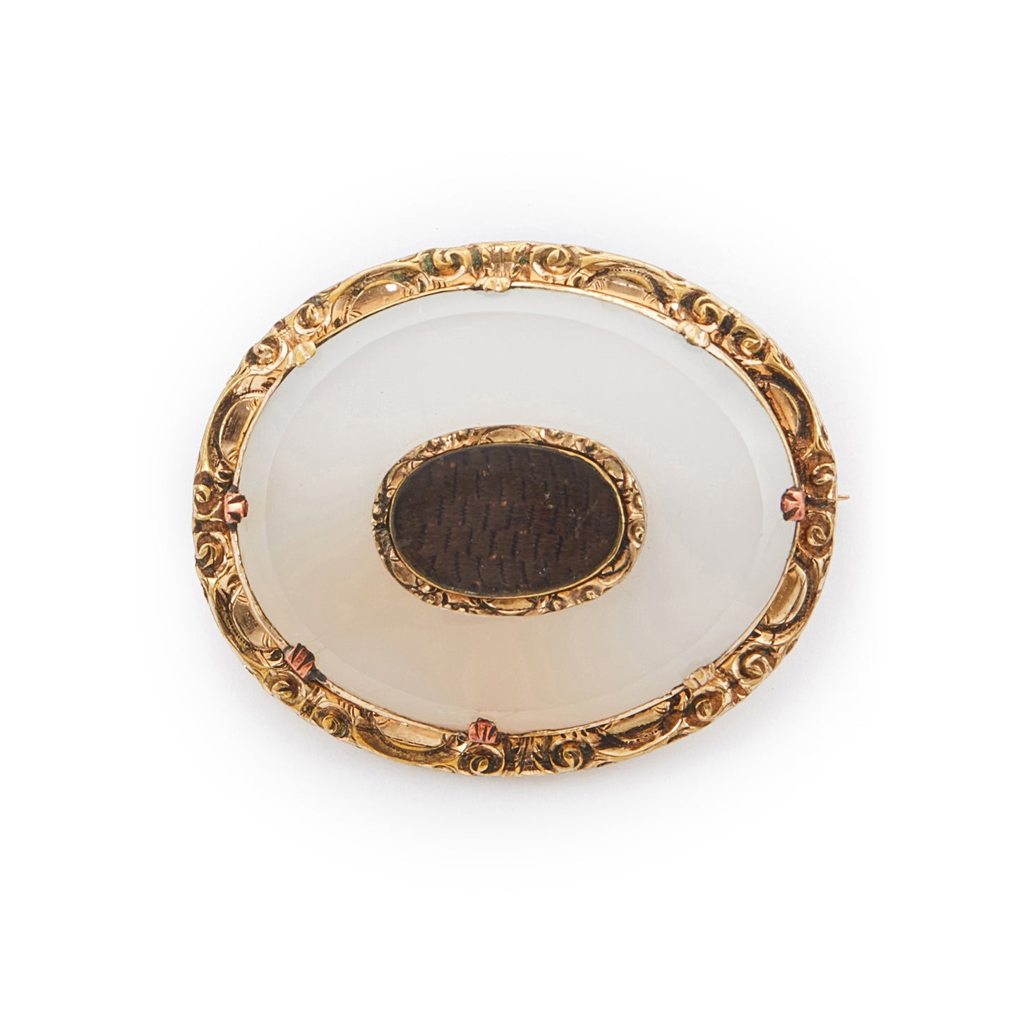 Ornate Victorian gold-plated mourning brooch claw-set with an opaque white agate disk and woven hair encased behind glass.