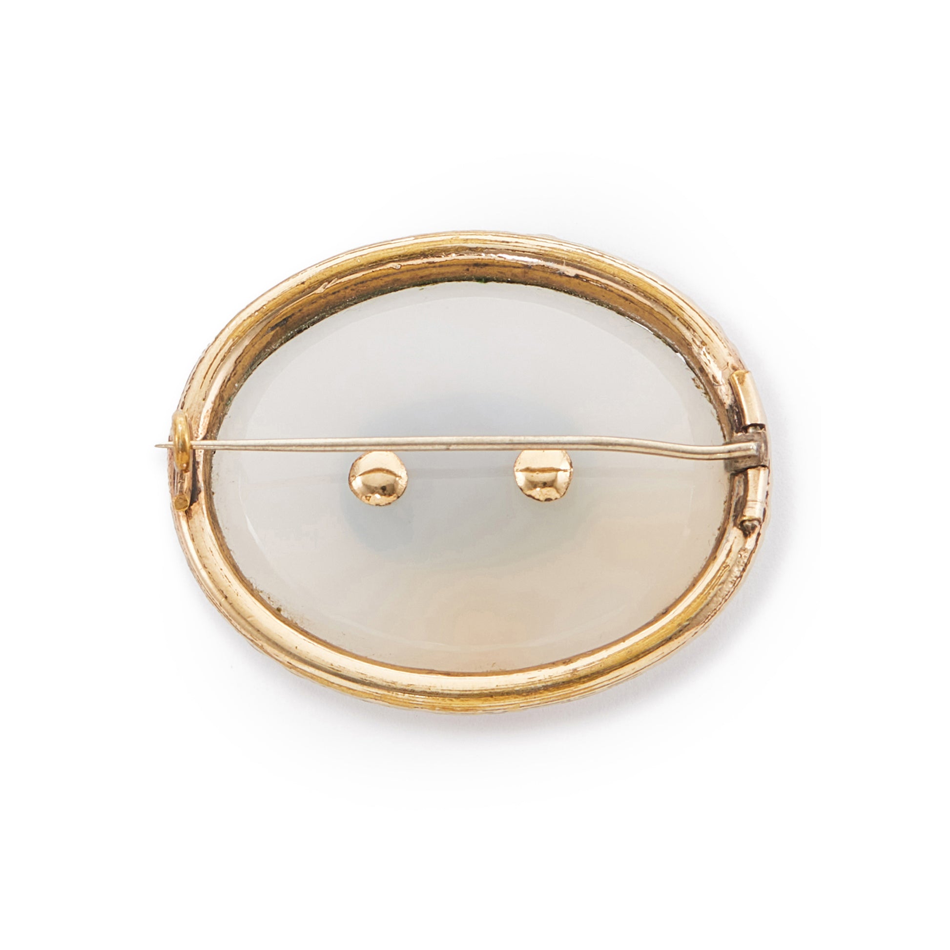 Ornate Victorian gold-plated mourning brooch claw-set with an opaque white agate disk and woven hair encased behind glass.