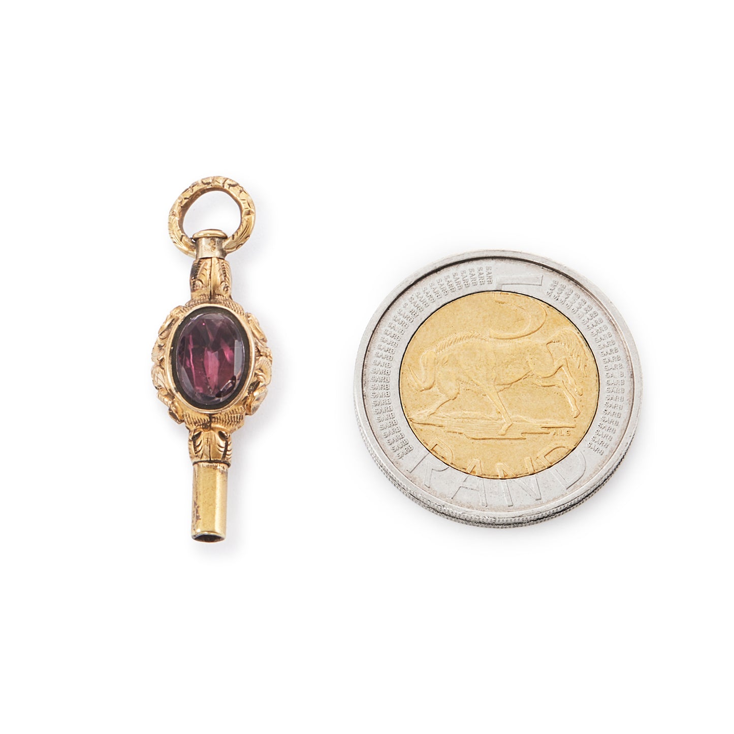 Quaint miniature Victorian gold-plated watch key set with an amethyst on one side and white agate on the other.
