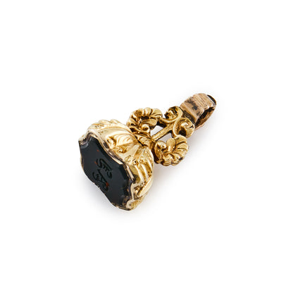 Small Victorian gold cased bloodstone seal with ornate detail.