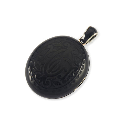 Exquisite Victorian jet monogrammed silver mourning locket which opens to a lock of hair behind glass, and space for a photograph. The bail has black enamelling.