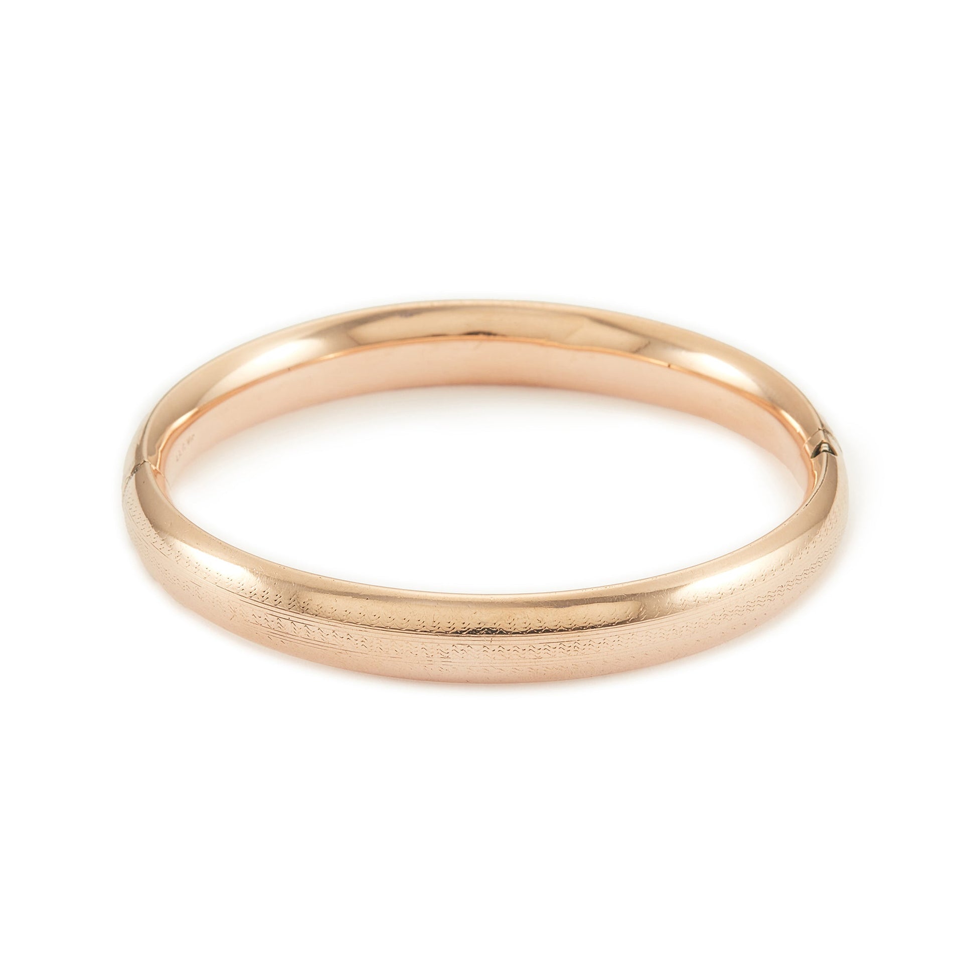 Stylish Victorian rose gold cased hollow bangle with faint engraving on one side.