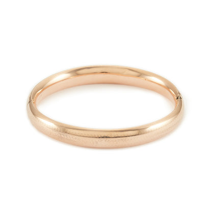 Stylish Victorian rose gold cased hollow bangle with faint engraving on one side.