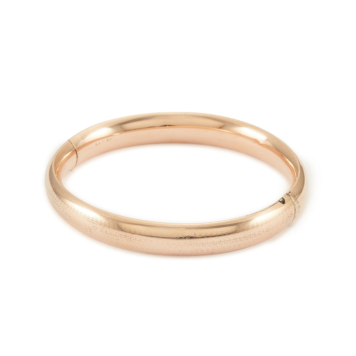 Stylish Victorian rose gold cased hollow bangle with faint engraving on one side.