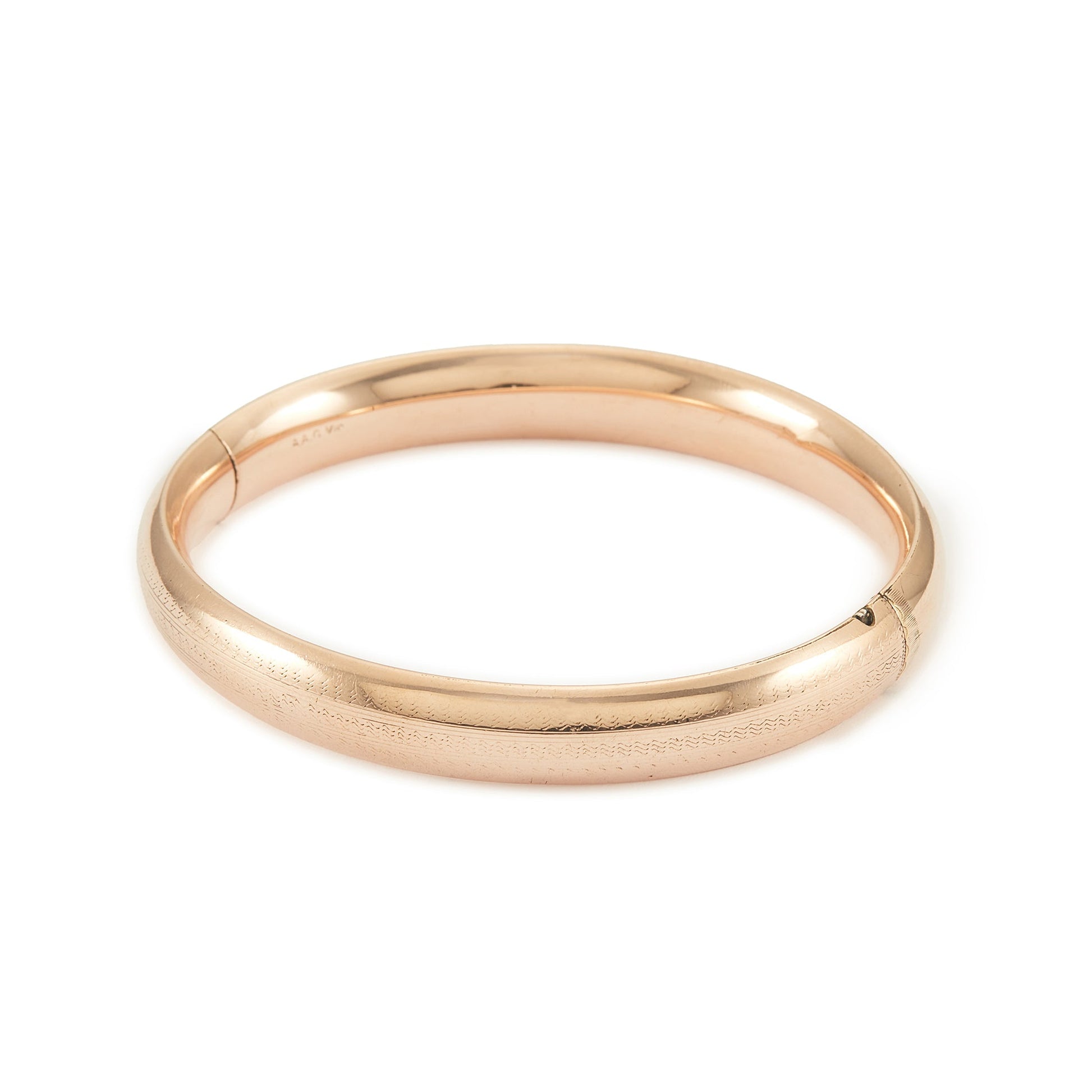 Stylish Victorian rose gold cased hollow bangle with faint engraving on one side.