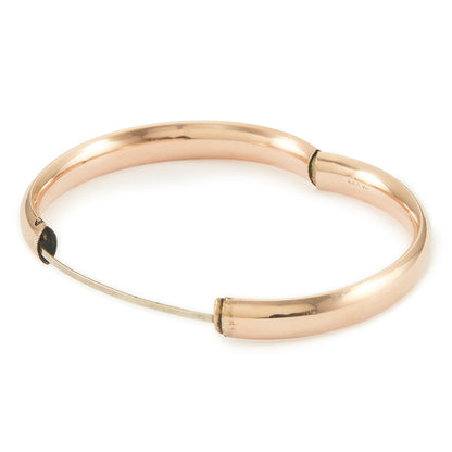 Stylish Victorian rose gold cased hollow bangle with faint engraving on one side.