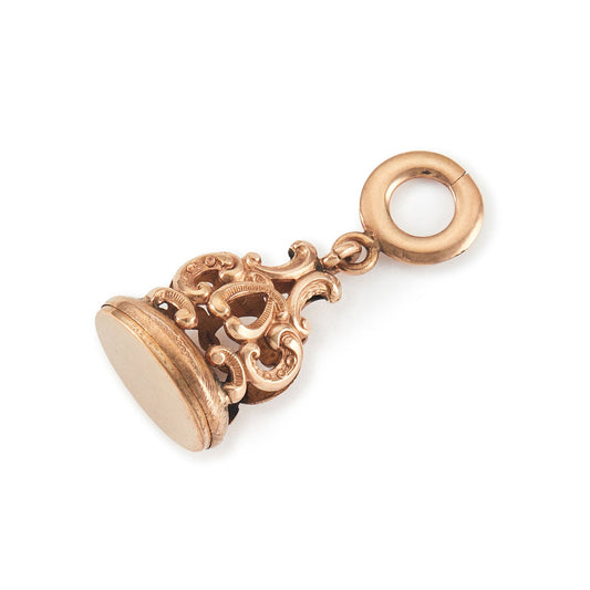 Quaint Victorian rose gold cased fob with intricate repoussé detail.