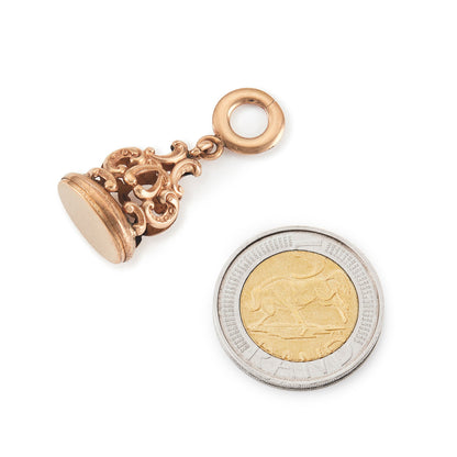Quaint Victorian rose gold cased fob with intricate repoussé detail.