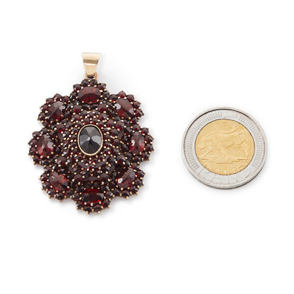 Impressive silver-gilt Victorian pendant set with a variety of beautifully faceted Bohemian garnets in four tiers.