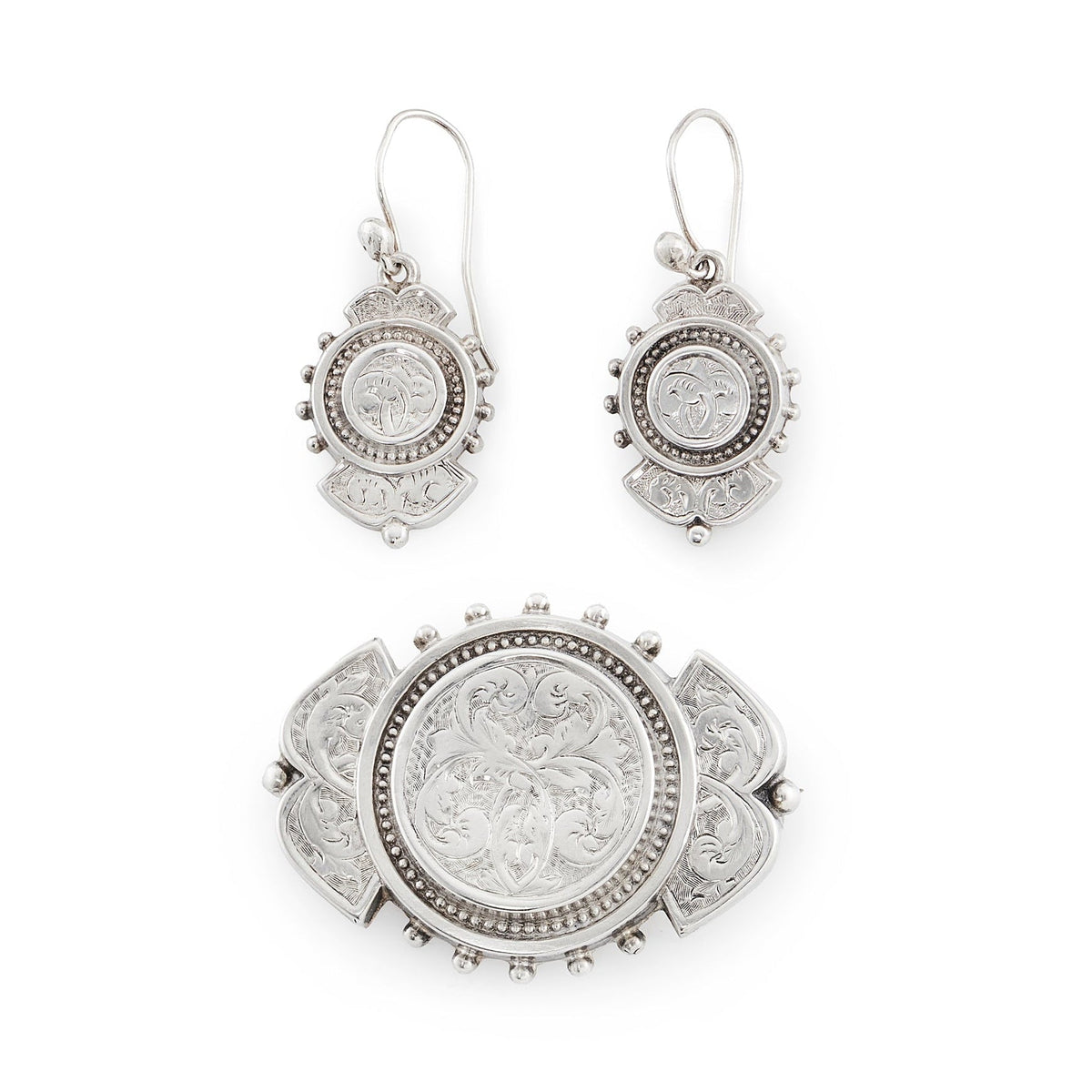 Beautifully engraved silver Victorian dangling earrings with shepherd's hooks, accompanied by a brooch with the same design.