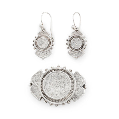 Beautifully engraved silver Victorian dangling earrings with shepherd's hooks, accompanied by a brooch with the same design.