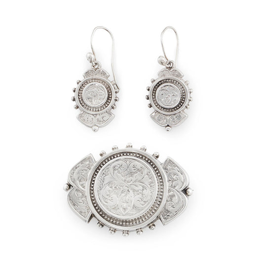 Beautifully engraved silver Victorian dangling earrings with shepherd's hooks, accompanied by a brooch with the same design.