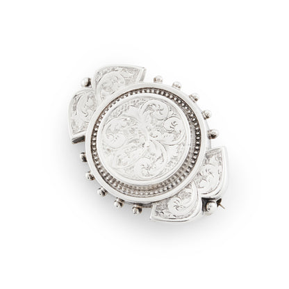 Beautifully engraved silver Victorian dangling earrings with shepherd's hooks, accompanied by a brooch with the same design. 