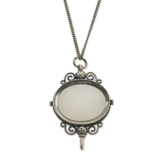 Charming Victorian oxidised silver and agate key winder pendant on a long chain.