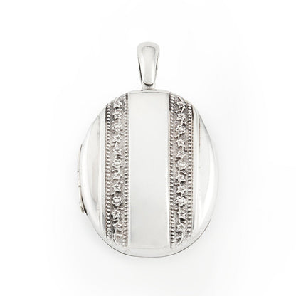 Beautiful Victorian silver locket embossed with intricate flower motifs on both sides. The locket can take two photographs.