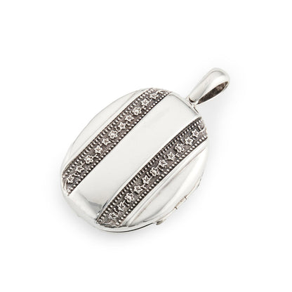 Beautiful Victorian silver locket embossed with intricate flower motifs on both sides. The locket can take two photographs.