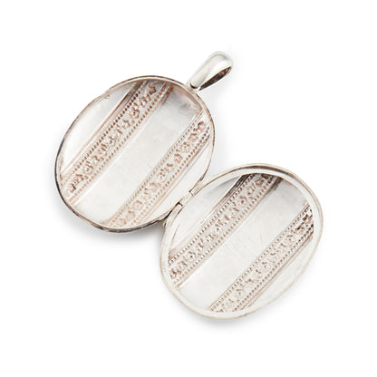 Beautiful Victorian silver locket embossed with intricate flower motifs on both sides. The locket can take two photographs.