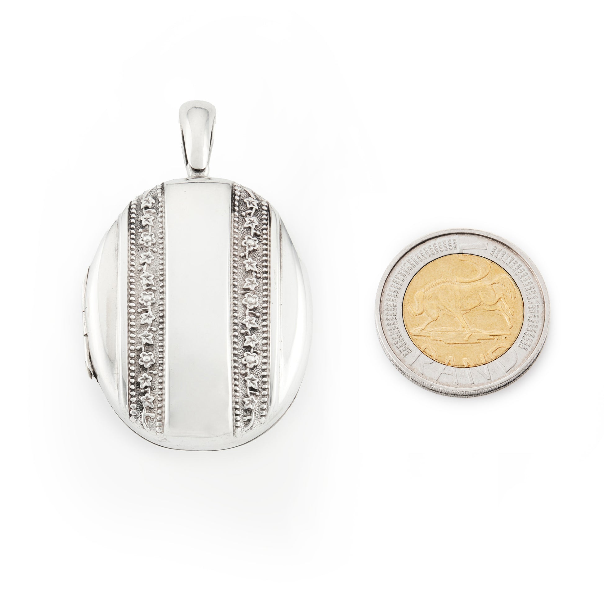 Beautiful Victorian silver locket embossed with intricate flower motifs on both sides. The locket can take two photographs.