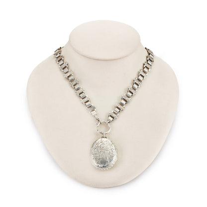 Classic Victorian silver locket on choker with ornate floral engraving.