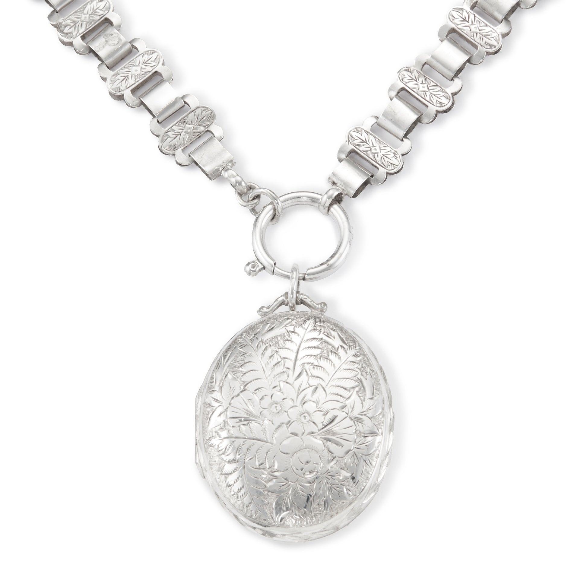 Classic Victorian silver locket on choker with ornate floral engraving.