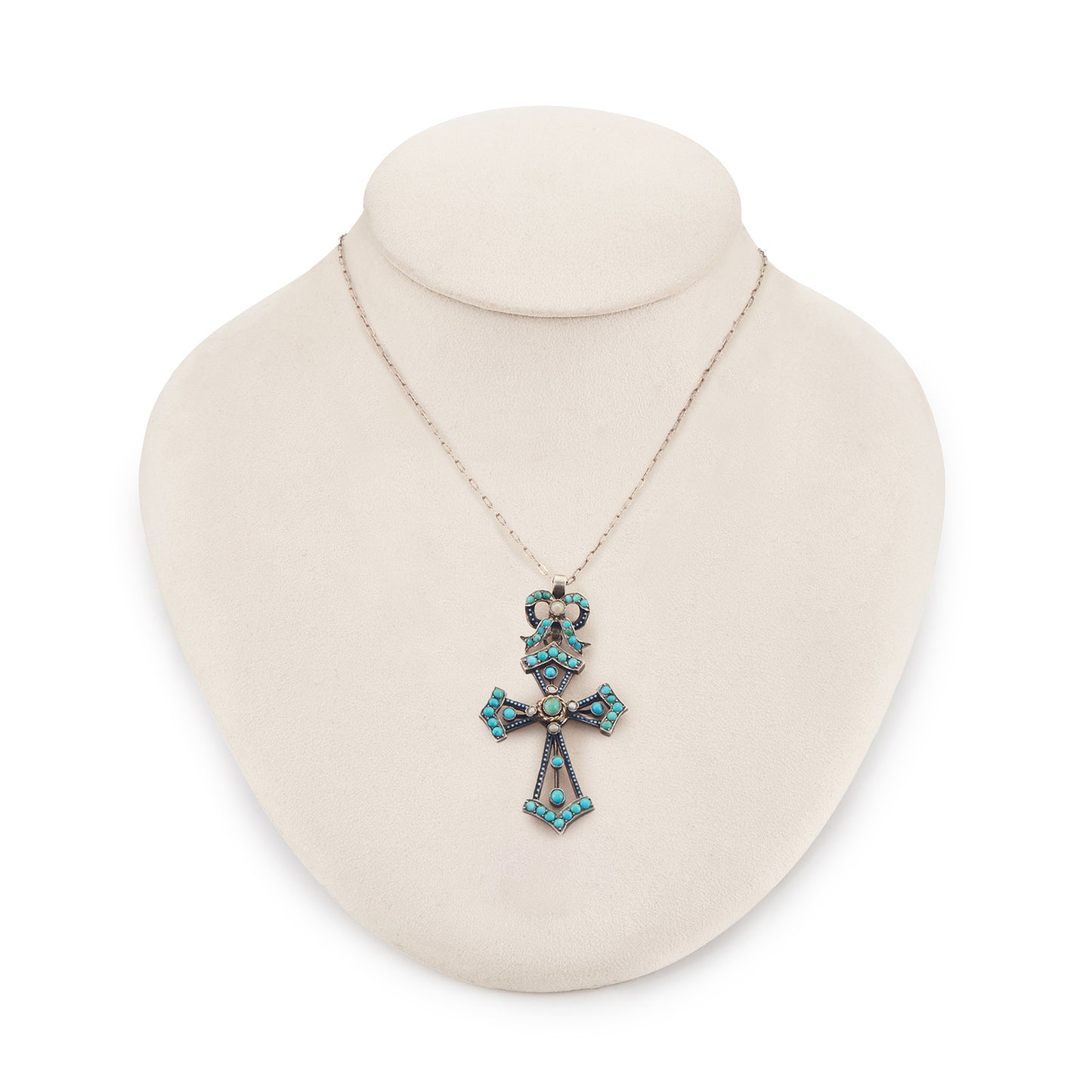 Exquisite Victorian silver enamelled turquoise cross and bow pendant set with five seed pearls, dangling from a long and intricate chain.
