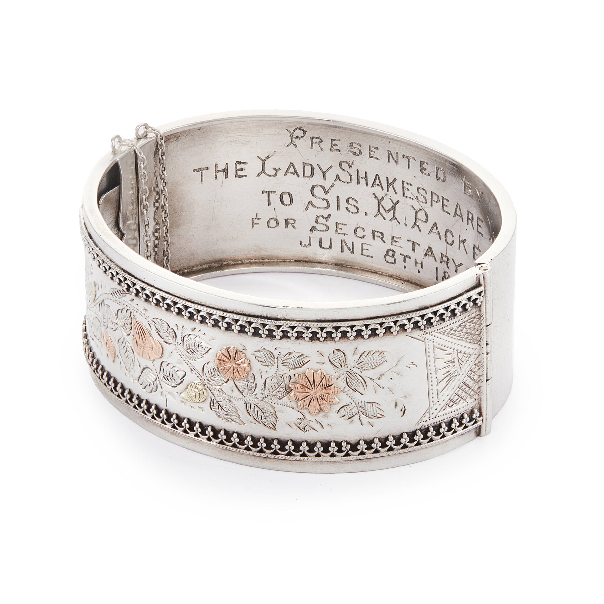 Beautiful Victorian silver and gold bangle embossed with a floral design and Etruscan detail around the rim. Safety chain attached.