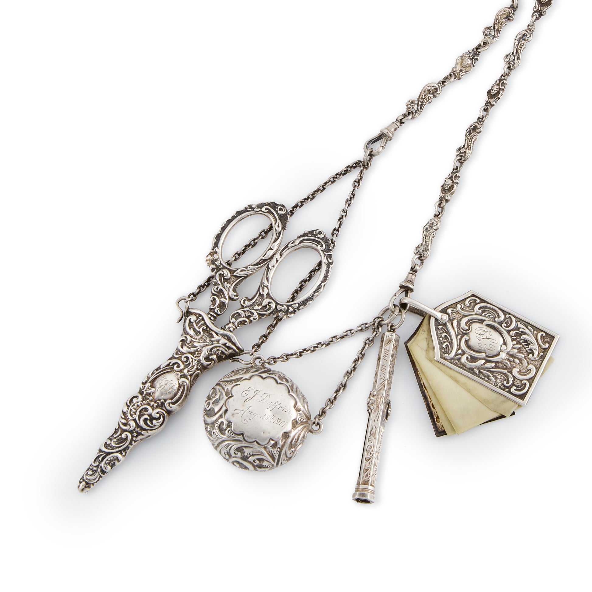 Magnificent Victorian sterling silver chatelaine with household tools dangling from chains with dog clips. The decorative belt hook holds a of a pair of scissors, a pencil, a pill box, a miniature note pad, a lorgnette with mother of pearl casing, a beautiful vinaigrette with silver-gilt inside, a shoe hook, a perfume bottle and a thimble holder with a thimble inside.
