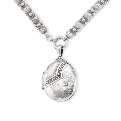 Beautiful Victorian sterling silver locket with intricate detail on an ornate sterling silver chain. Faint inscription at the back of the locket.