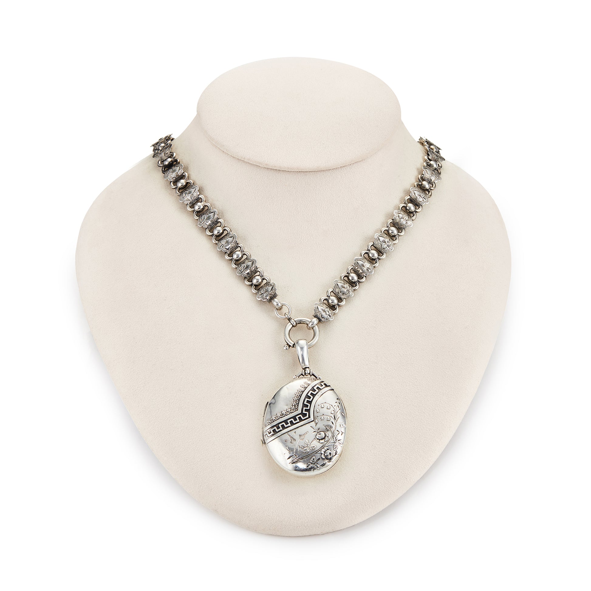 Beautiful Victorian sterling silver locket with intricate detail on an ornate sterling silver chain. Faint inscription at the back of the locket.