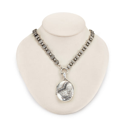 Beautiful Victorian sterling silver locket with intricate detail on an ornate sterling silver chain. Faint inscription at the back of the locket.