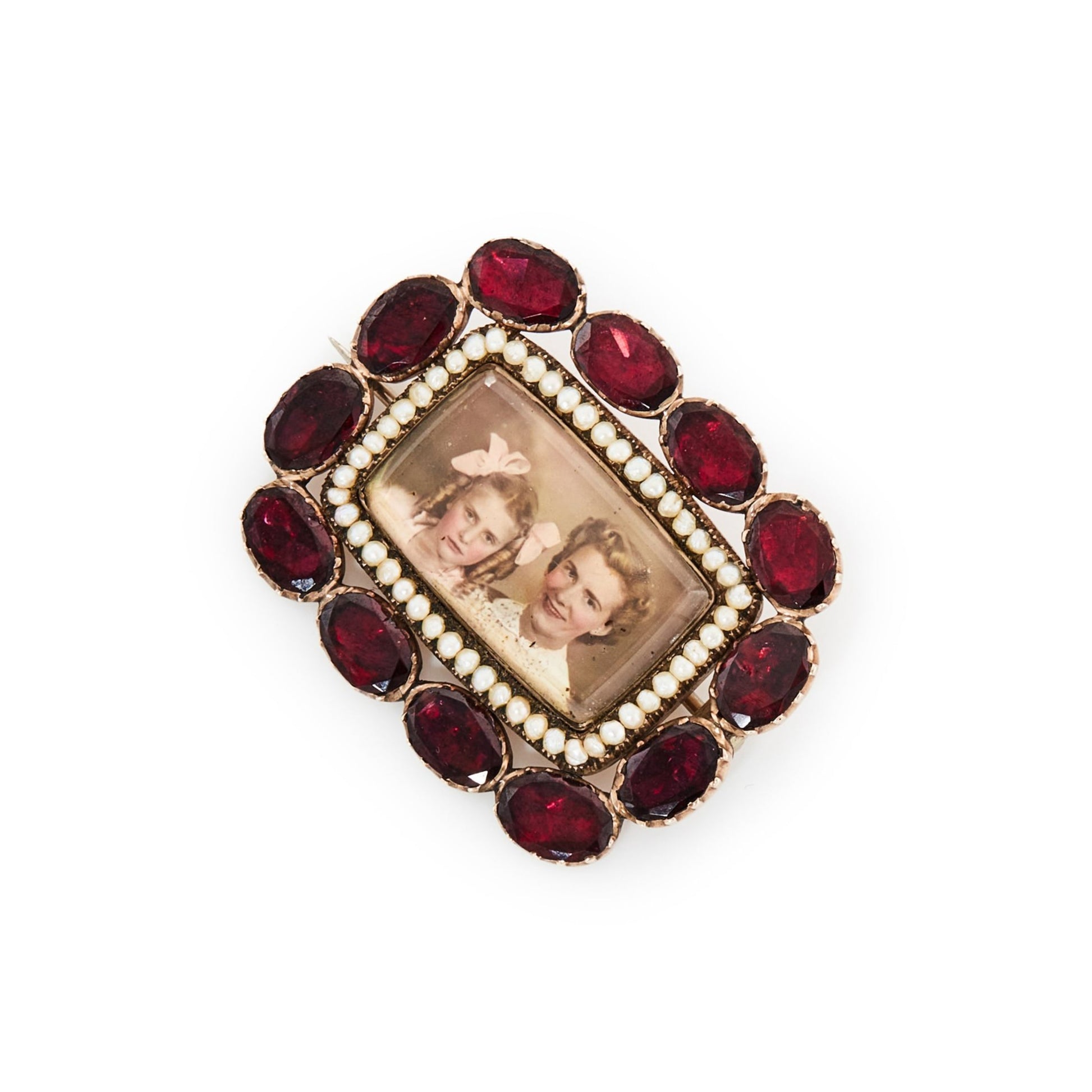 Very unusual Victorian 9ct gold memento mori picture brooch depicting a mother and daughter, surrounded by fine seed pearls and twelve oval shaped deep red old cut garnets.