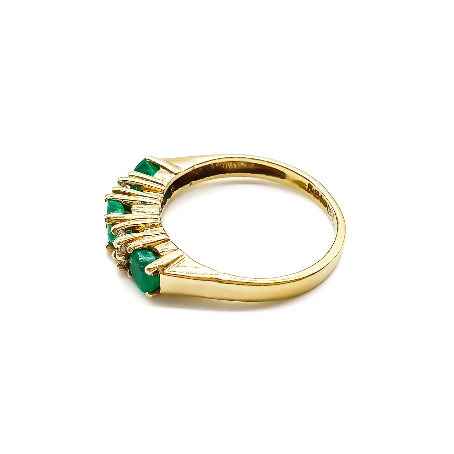 Classic vintage 14ct yellow gold ring set with three round emeralds and four small diamonds.