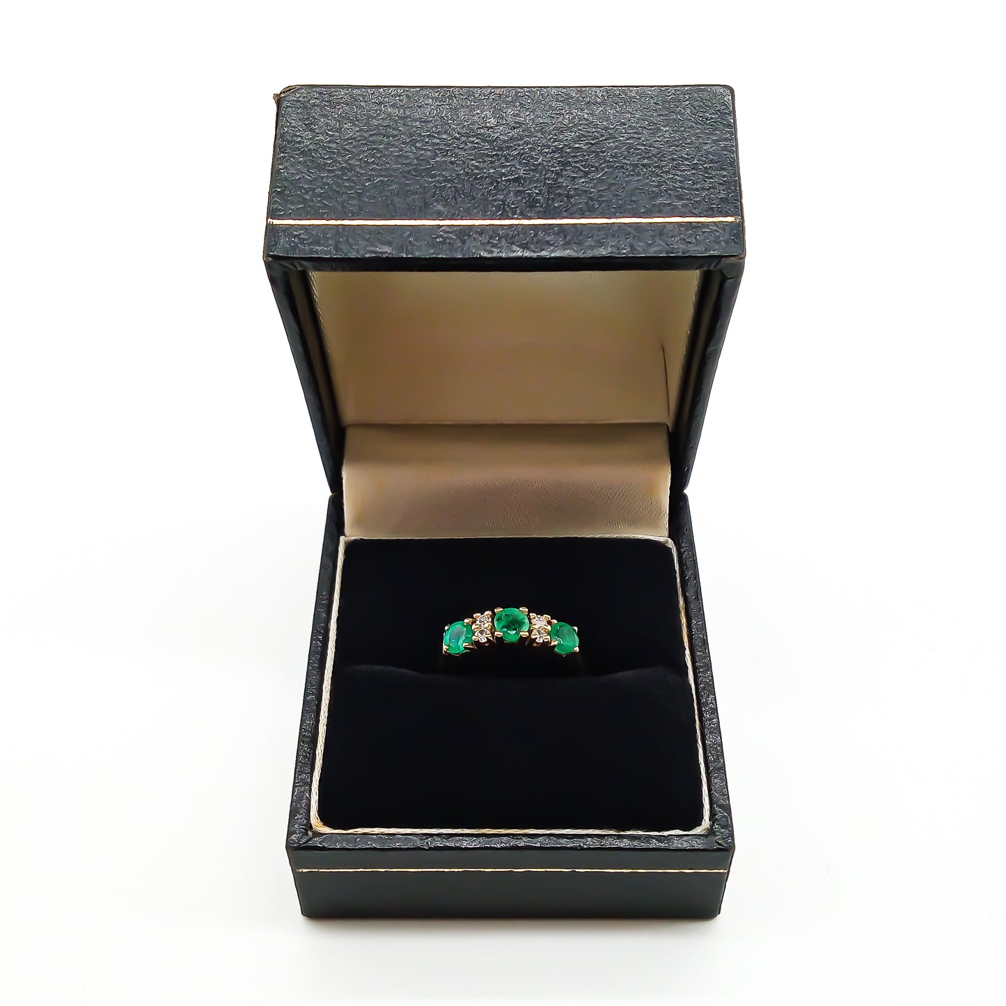 Classic vintage 14ct yellow gold ring set with three round emeralds and four small diamonds.