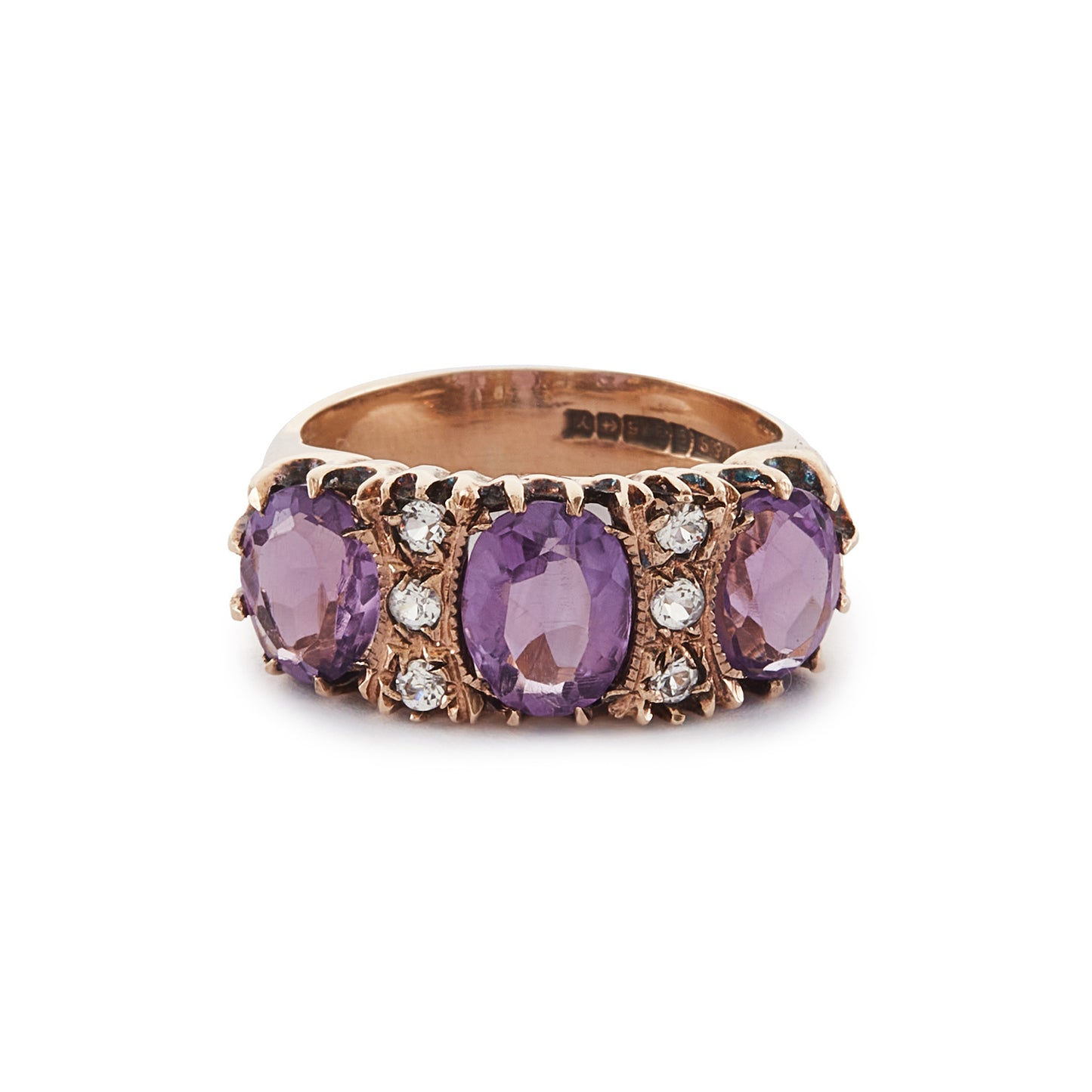9ct Rose gold trilogy ring set with three beautifully faceted purple amethysts, interspersed with small, white, round-cut spinels.