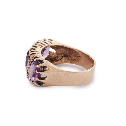 9ct Rose gold trilogy ring set with three beautifully faceted purple amethysts, interspersed with small, white, round-cut spinels.