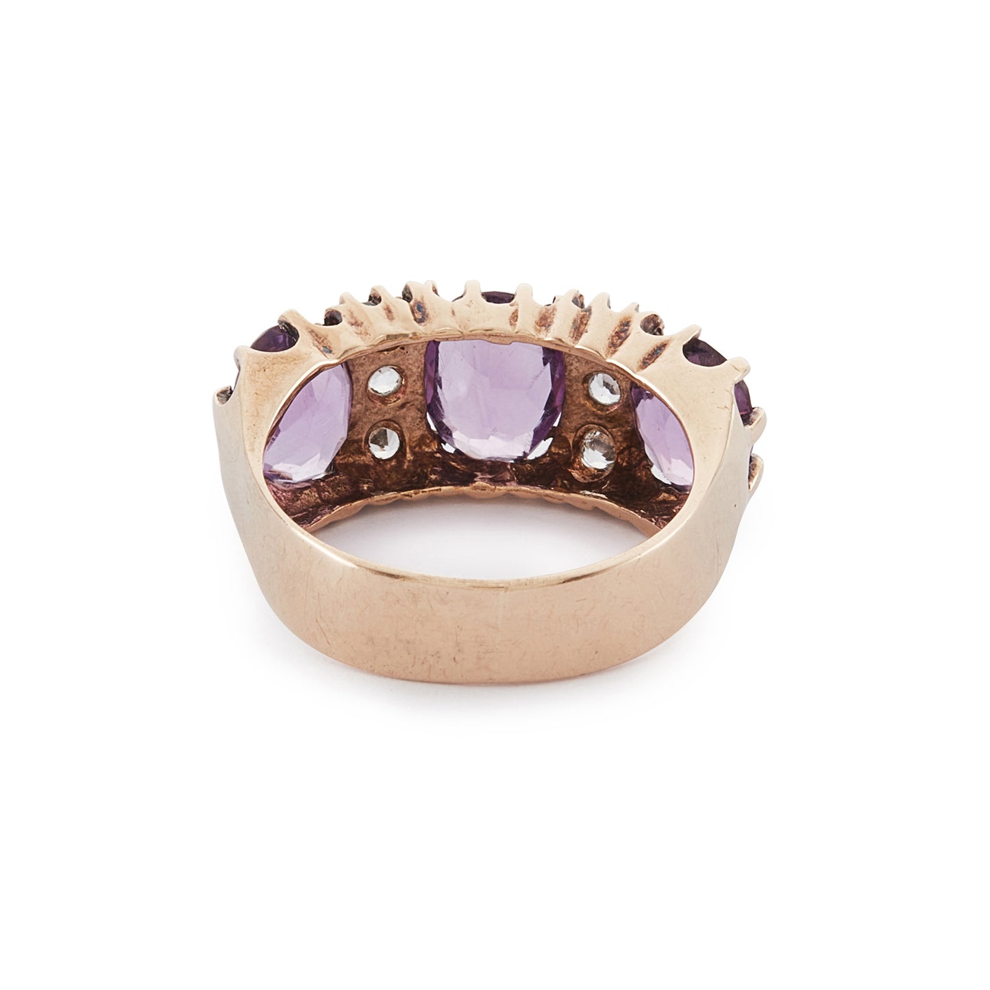 9ct Rose gold trilogy ring set with three beautifully faceted purple amethysts, interspersed with small, white, round-cut spinels.