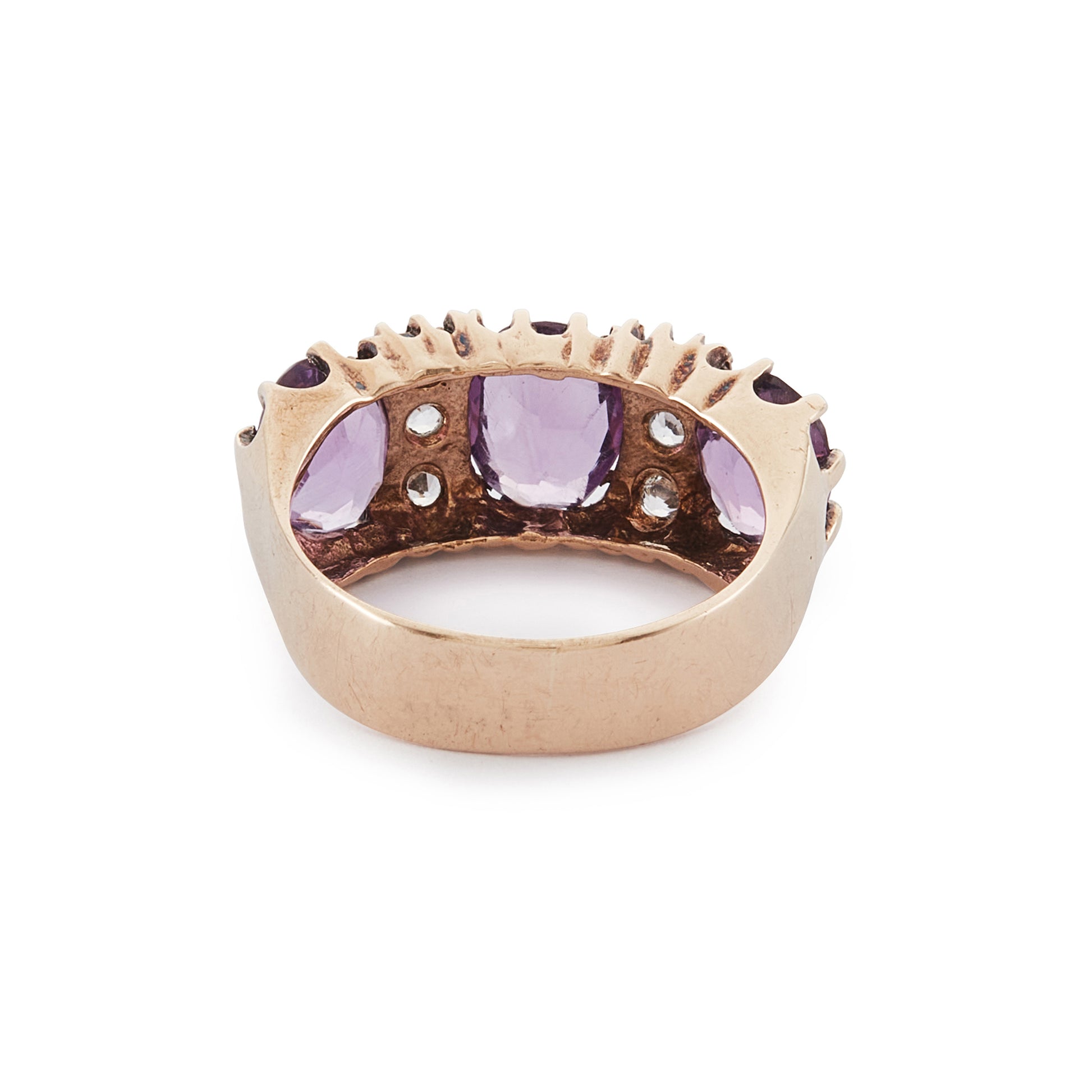 9ct Rose gold trilogy ring set with three beautifully faceted purple amethysts, interspersed with small, white, round-cut spinels.