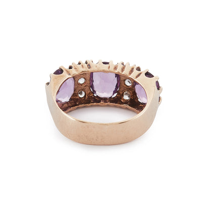 9ct Rose gold trilogy ring set with three beautifully faceted purple amethysts, interspersed with small, white, round-cut spinels.
