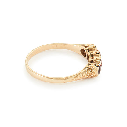 Classic vintage 9ct yellow gold ring set with four faceted garnets.