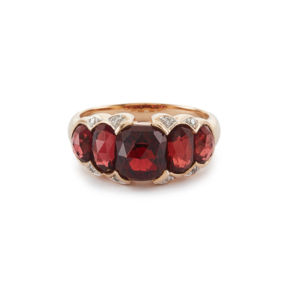 Stunning vintage 9ct gold ring set with five beautifully faceted garnets and eight small diamonds around the stones.