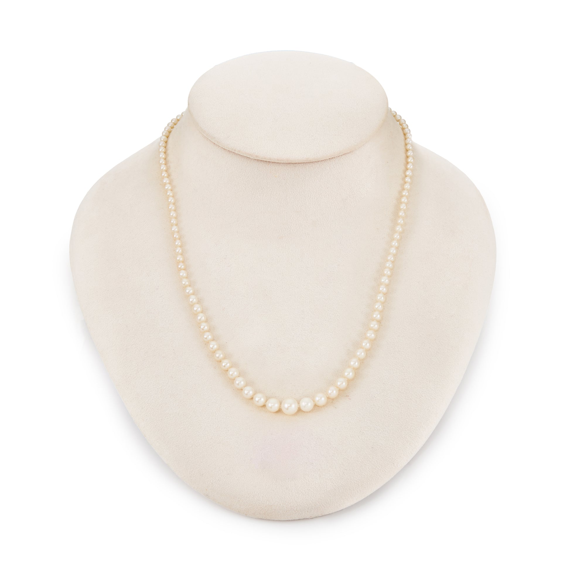 Graduated string of lustrous vintage cultured seawater pearls with sterling silver clasp set with a single pearl.