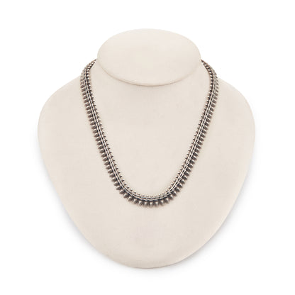 Stylish silver choker necklace with ornate detail and a large bolt ring clasp.
