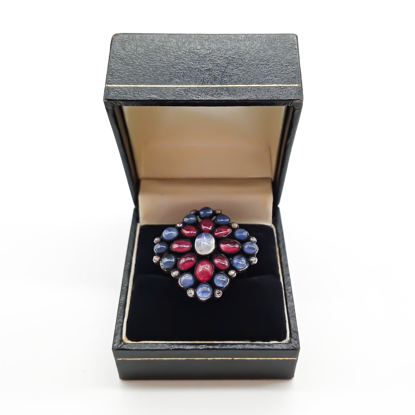 Gorgeous vintage oxidised sterling silver ring set with cabochon sapphires, rubies, a centre moonstone and tiny old-cut diamonds.